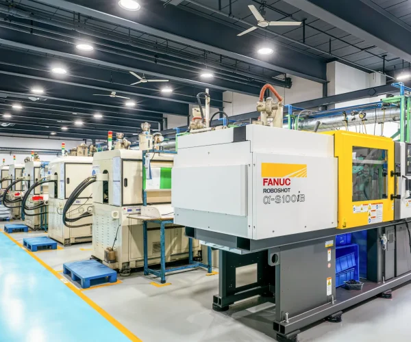 Precision injection molding workshop — FANUC machines and molded plastic parts at Hanstar